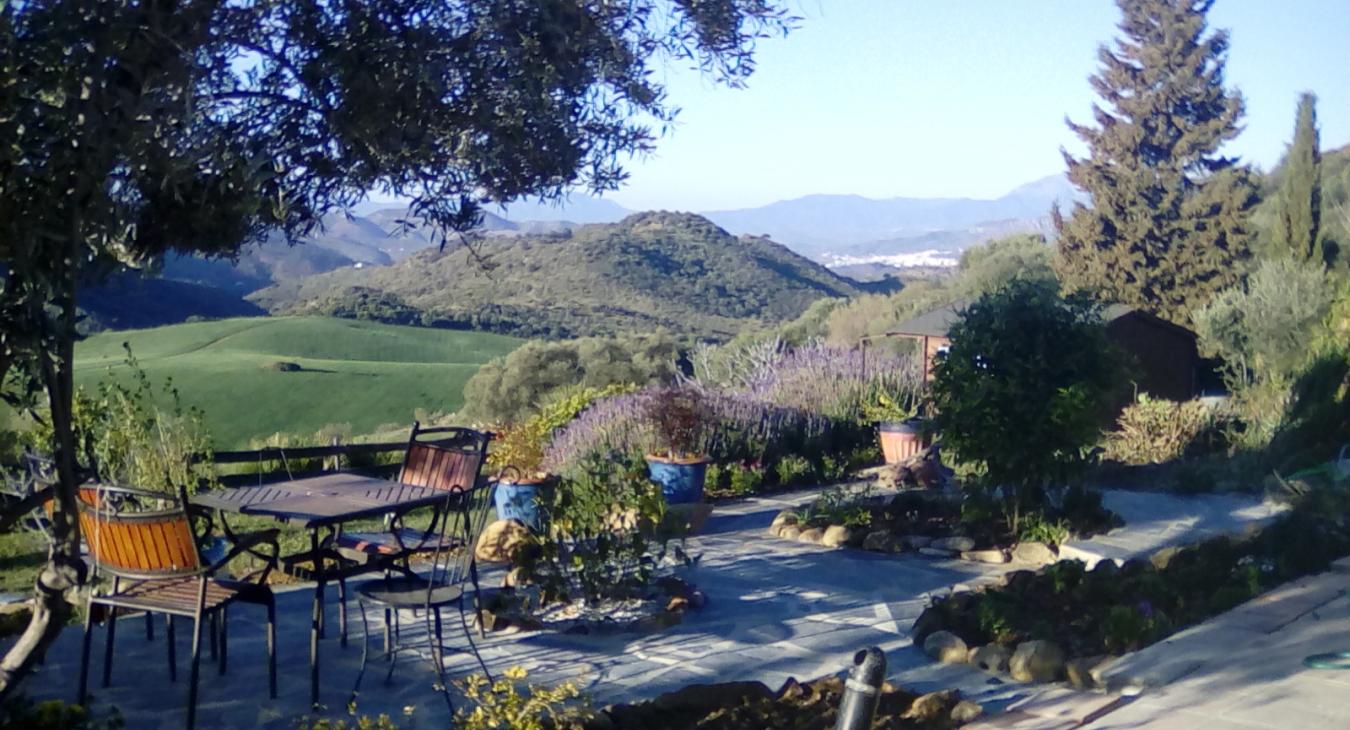 This garden patio offers writers on a Secret World Writing Retreat a little welcome shade and a marvellous view down the Valle del Guadalhorce.